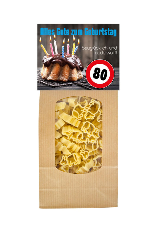Die Pasta sind in Form von einem Gluecksschweinchen. Auf der Vorderseite steht der Spruch: 80 Alles Gute zum Geburtstag. Saugluecklich und nudelwohl.