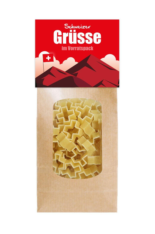 Die leckeren Pasta mit der Aufschrift: Schweizer Gruesse im Vorratspack. Die Motiv Pasta sind in Form eines Schweizerkreuzes. Schweizer Souvenir als Geschenk.