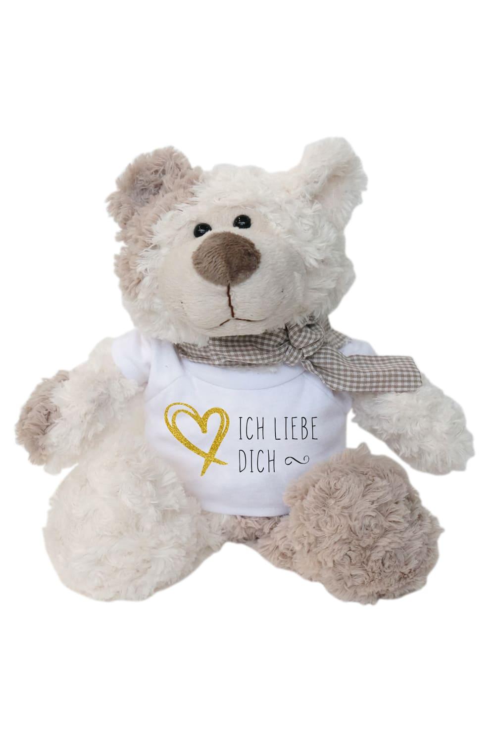 Der kuschelige und weiche Plueschbaer ist ein ideales Geschenk fuer jeden Anlass. Der Teddybaer traegt eine Schleife um den Hals und wirkt somit sehr modebewusst. Dazu traegt der Plueeschbaer ein weisses Mini T-Shirt mit dem Spruch: Ich liebe Dich. Auf dem Shirt ist ausserdem ein Herz abgebildet. Der Baer misst stehend 29 cm.